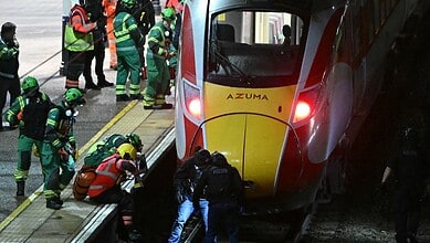 _Police search the track beneath a train after stabbing in Huntingdon, UK.