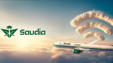 Saudia aircraft flying above the clouds with WiFi signal icons formed from clouds, symbolising in-flight internet connectivity.
