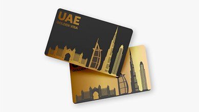 Illustration of UAE Golden Visa cards featuring gold and black designs with silhouettes of iconic Dubai landmarks, including Burj Khalifa and Burj Al Arab.