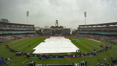 Groundsmen cover the field amid rain at the DY Patil Stadium ahead of the ICC Women's World Cup 2025 cricket final match between India Women and South Africa Women, in Navi Mumbai, Sunday, Nov. 2, 2025. (PTI Photo/Kunal Patil)