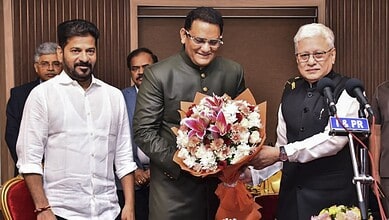 Congress leader and former cricketer Mohammad Azharuddin takes oath as a minister in Telangana cabinet during a swearing-in ceremony at Raj Bhavan in Hyderabad.