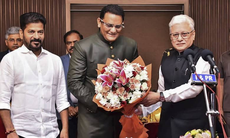 Congress leader and former cricketer Mohammad Azharuddin takes oath as a minister in Telangana cabinet during a swearing-in ceremony at Raj Bhavan in Hyderabad.