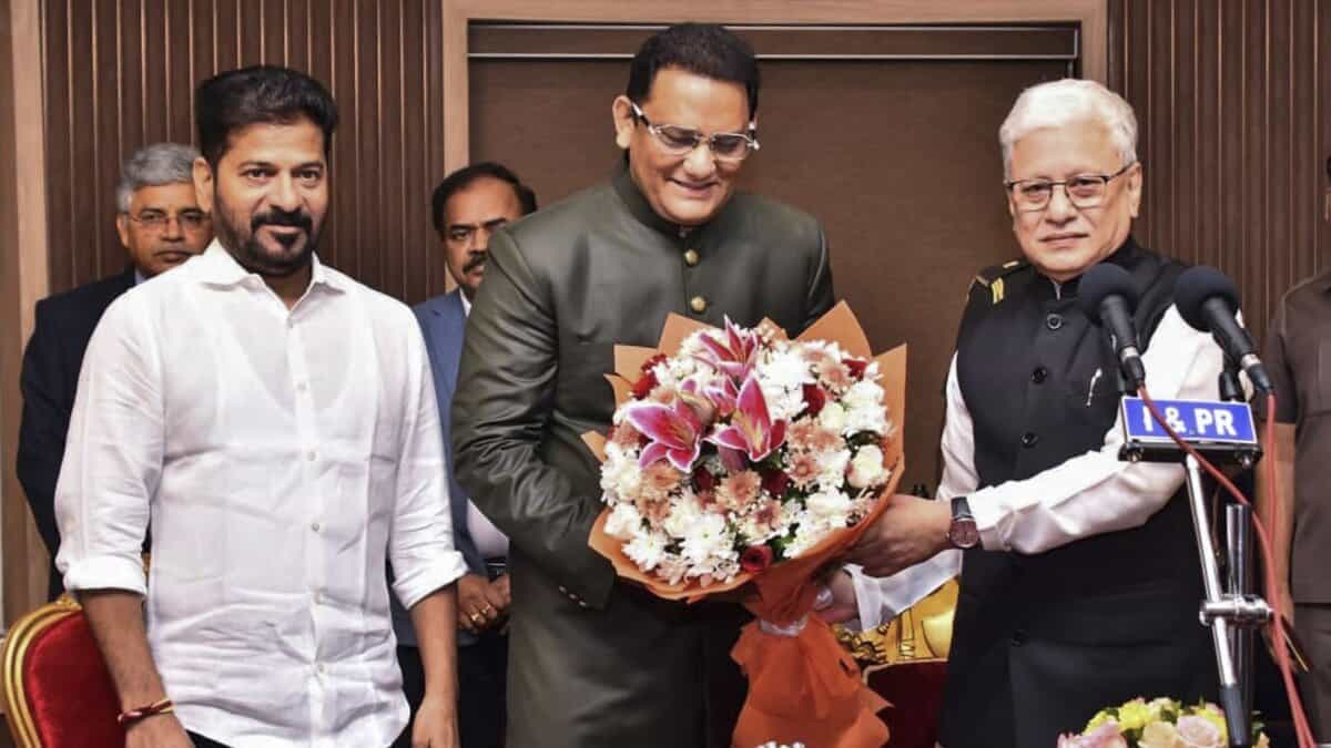 Congress leader and former cricketer Mohammad Azharuddin takes oath as a minister in Telangana cabinet during a swearing-in ceremony at Raj Bhavan in Hyderabad.