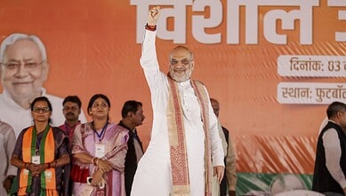 Union Home Minister Amit Shah waves to the gathering during a rally ahead of the Bihar Assembly elections in Sitamarhi.