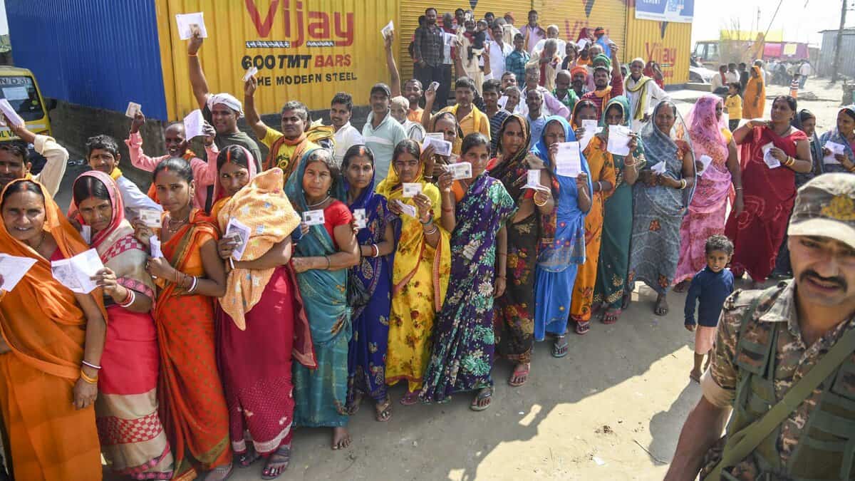 Voters wait in a queue to cast votes at a polling station during the first phase of the Bihar Assembly elections at Bakhtiarpur in Patna on Thursday. (PTI Photo)