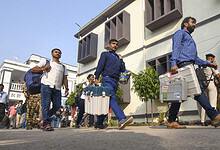 Polling officials with EVM and other election material leave for their respective booths on the eve of the first phase of the Bihar Assembly elections, in Patna on Wednesday (PTI)