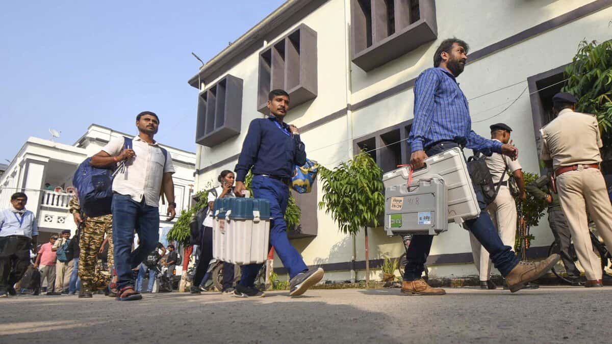 Polling officials with EVM and other election material leave for their respective booths on the eve of the first phase of the Bihar Assembly elections, in Patna on Wednesday (PTI)