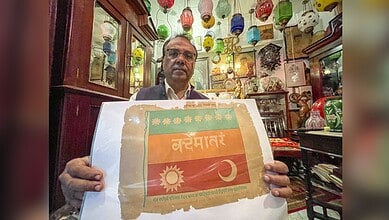 Antique collector Zafar Ansari displays a tricolour flag linked to the legacy of Vande Mataram, in Indore, Madhya Pradesh. (PTI Photo/Harshwardhan Prakash)