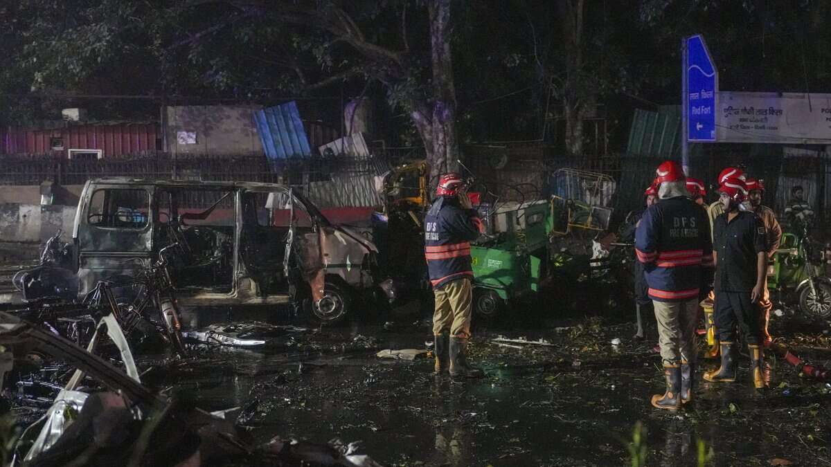 Firefighters at the spot after a blast occurred in a parked car near Red Fort, leaving multiple vehicles in flames in New Delhi on Monday. At least eight people have been killed. (PTI Photo/Salman Ali)