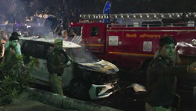 Police personnel at the spot after a blast occurred in a parked car near Red Fort, leaving multiple vehicles in flames in New Delhi on Monday. Eight people have died and atleast 24 injured. (PTI Photo/Salman Ali)