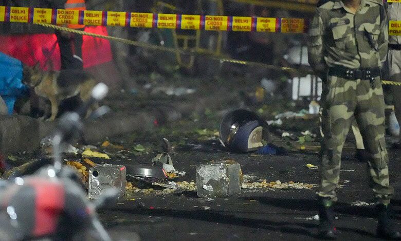 Tin containers and other items lie near the spot after a blast occurred in a parked car near Red Fort leaving multiple vehicles in flames in New Delhi on Monday. At least nine people were killed and 24 others suffered injuries in the incident. (PTI Photo/Salman Ali)
