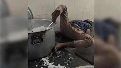 A watchman sleeps with his foot on the vessel in hostel in Telangana