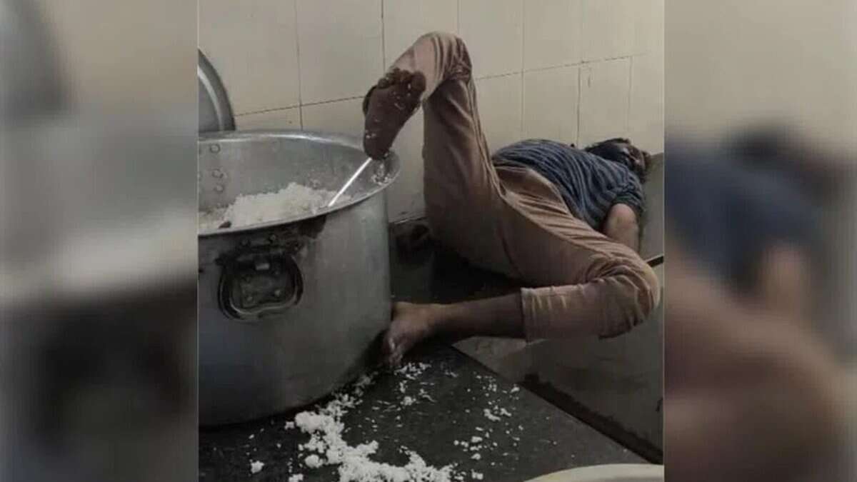 A watchman sleeps with his foot on the vessel in hostel in Telangana