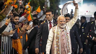 Prime Minister Narendra Modi waves a gamcha as he arrives during the celebration of NDA's victory in the Bihar Assembly elections at BJP headquarters in New Delhi on Friday.