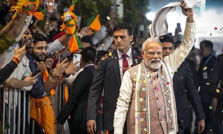 Prime Minister Narendra Modi waves a gamcha as he arrives during the celebration of NDA's victory in the Bihar Assembly elections at BJP headquarters in New Delhi on Friday.