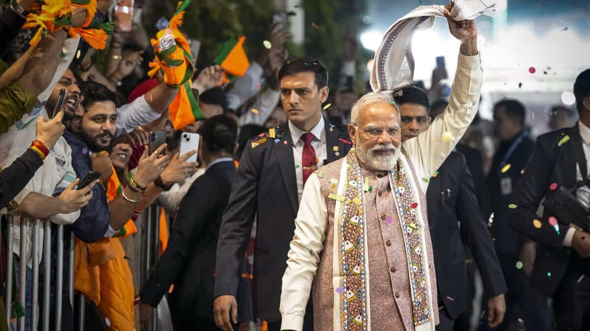 Prime Minister Narendra Modi waves a gamcha as he arrives during the celebration of NDA's victory in the Bihar Assembly elections at BJP headquarters in New Delhi on Friday.