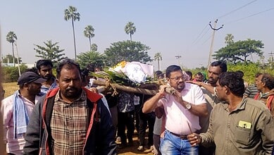 People carry Dharmaia's body