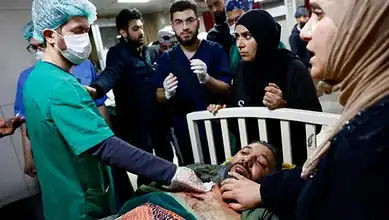 A wounded man receives emergency treatment at a hospital in Damascus after an Israeli raid in the Beit Jinn area of southern Syria on November 28.