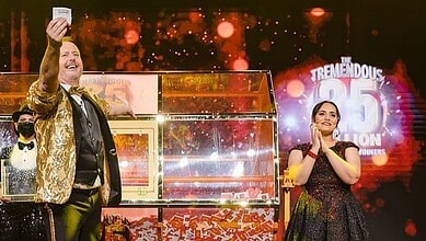 Big Ticket Abu Dhabi hosts celebrate on stage as they announce the Dh 25 million jackpot winner during a live draw, with confetti and bright lights in the background.