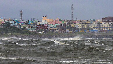 High waves lash the Kasimedu shoreline amid rough sea conditions in the wake of the Cyclone Ditwah in Chennai on Sunday. (PTI Photo)