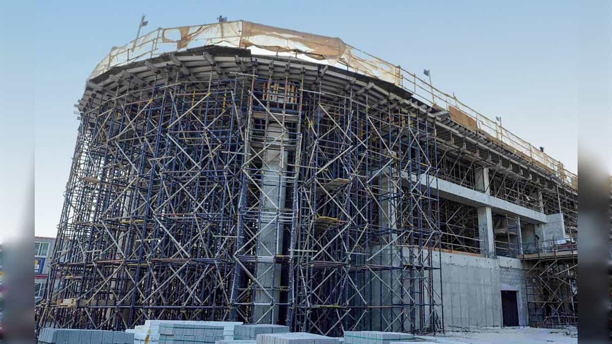 A partially built vertiport structure surrounded by dense scaffolding at a construction site in Dubai.