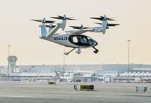 An electric vertical take-off and landing (eVTOL) air taxi operates during a test flight at Al Maktoum International Airport in Dubai.