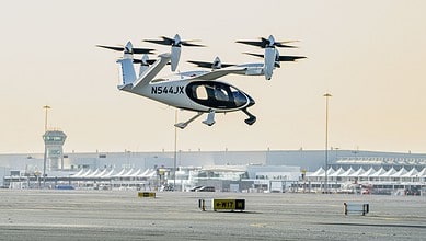 An electric vertical take-off and landing (eVTOL) air taxi operates during a test flight at Al Maktoum International Airport in Dubai.