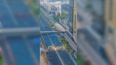 Aerial view of Dubai Run 2025 participants filling Sheikh Zayed Road near the Museum of the Future.