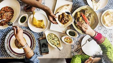 top view of indian dining table with family sharing a meal