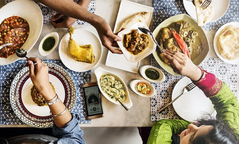 top view of indian dining table with family sharing a meal