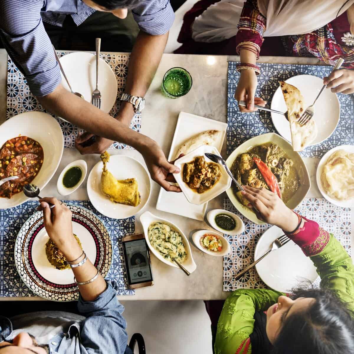 top view of indian dining table with family sharing a meal