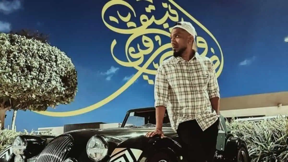 Advin Roy Netto standing beside a vintage car in Abu Dhabi.