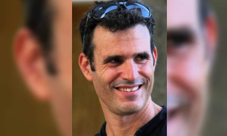 A smiling man with dark curly hair and sunglasses on his head, identified as Dror Or.
