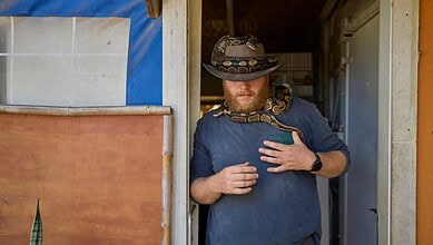 Israeli soldier takes part in animal therapy with a snake at the Back2Life farm in central Israel.