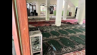 Interior of a mosque in Jakarta showing shattered glass, debris, and damaged prayer mats after explosions during Friday prayers.