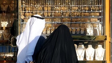Kuwaitis view gold jewellery displayed at a shop in Kuwait City.