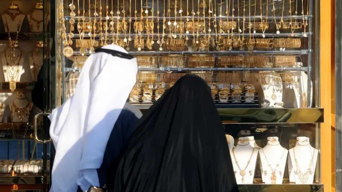 Kuwaitis view gold jewellery displayed at a shop in Kuwait City.