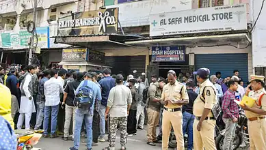 Crowd and police gathered outside a travel agency in Mallepally following news of a fatal bus accident involving Hyderabad pilgrims in Saudi Arabia.