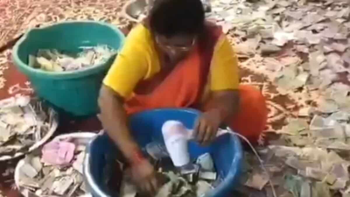 Devotee puts burning camphor in temple's donation box