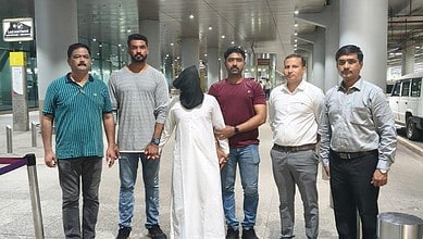 Mumbai Police personnel escort an accused after his deportation from the UAE at the airport.