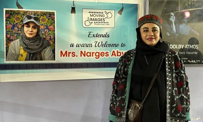 Iranian filmmaker Narges Abyar stands beside a welcome banner at the Hyderabad film festival.