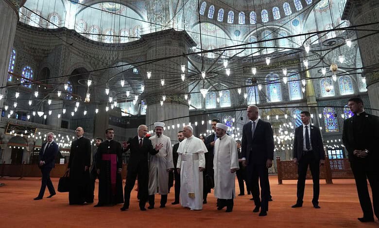 Pope Leo XIV tours the interior of Istanbul’s Sultan Ahmed Mosque with religious officials.