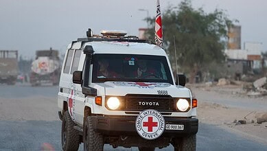 A Red Cross vehicle drives along a road in Gaza during a body handover operation between Israel and Gaza authorities.