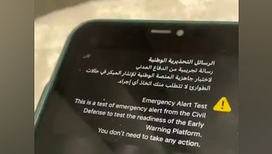 A mobile phone screen showing an emergency alert test message in Arabic and English from Saudi Civil Defense.