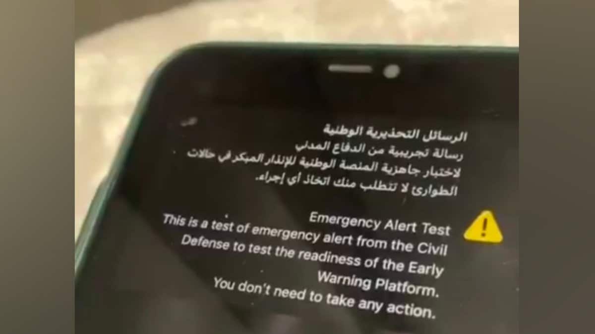 A mobile phone screen showing an emergency alert test message in Arabic and English from Saudi Civil Defense.