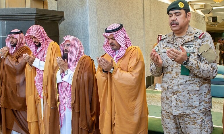 Saudi officials stand in prayer inside the Grand Mosque, with Sheikh Abdul Rahman Al-Sudais seen third from the right.