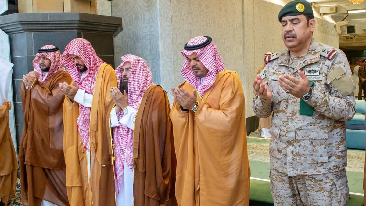 Saudi officials stand in prayer inside the Grand Mosque, with Sheikh Abdul Rahman Al-Sudais seen third from the right.