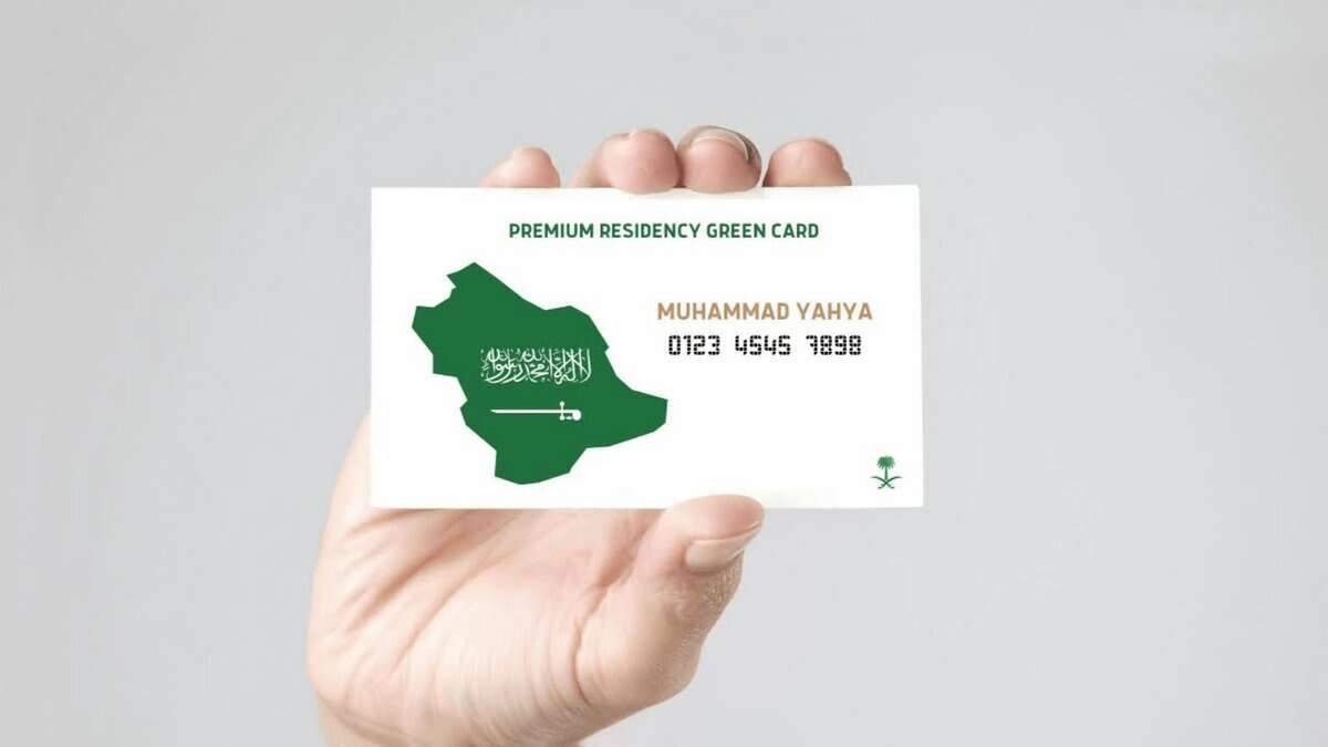 A person holds a Saudi Arabia Premium Residency Green Card showing the map of the Kingdom and the name Muhammad Yahya.