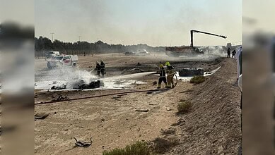 Firefighters extinguish burning debris at the Tejas jet crash site during the Dubai Airshow.