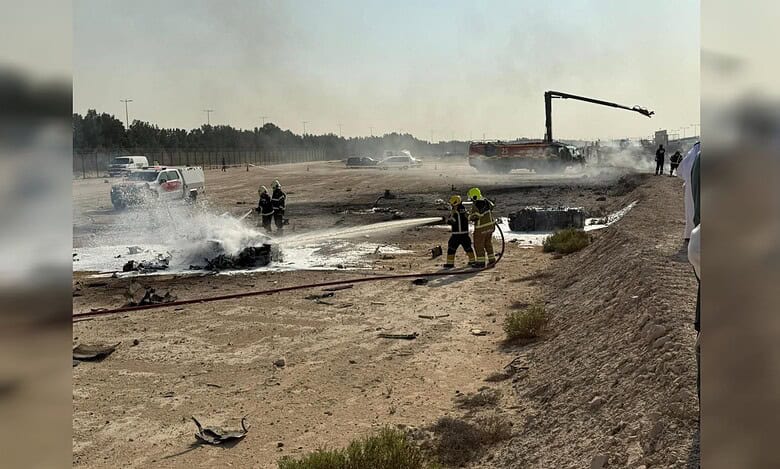 Firefighters extinguish burning debris at the Tejas jet crash site during the Dubai Airshow.